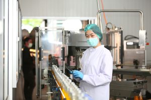 Production operator in a food processing plant inspecting a packaging line, highlighting Workvantage’s recruitment services for the food industry in Canada.