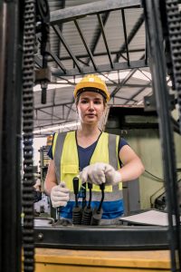 Worker operating machinery in a manufacturing plant, highlighting the expertise and specialized staffing solutions provided by Workvantage in manufacturing and warehousing.