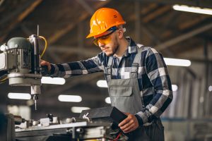 Worker operating a machine in a manufacturing environment, highlighting Workvantage's staffing solutions for skilled personnel in manufacturing.