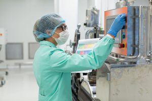 Food processing worker operating a control screen in a production plant, highlighting Workvantage’s specialized food processing staffing services.