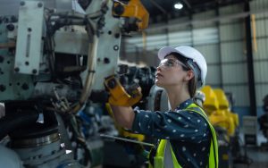 Engineer inspecting machinery in a factory, reflecting the technical and specialized staffing solutions in manufacturing provided by Workvantage.