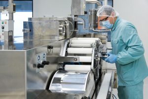 Food processing worker adjusting specialized machinery on a production line, emphasizing Workvantage’s staffing services for the food processing industry.