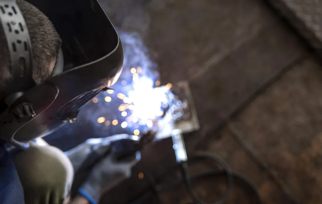 male-mechanic-working-his-workshop Close-up of a welder at work, highlighting Workvantage’s construction staffing services, providing skilled tradespeople to meet the demands of Canada’s construction industry.