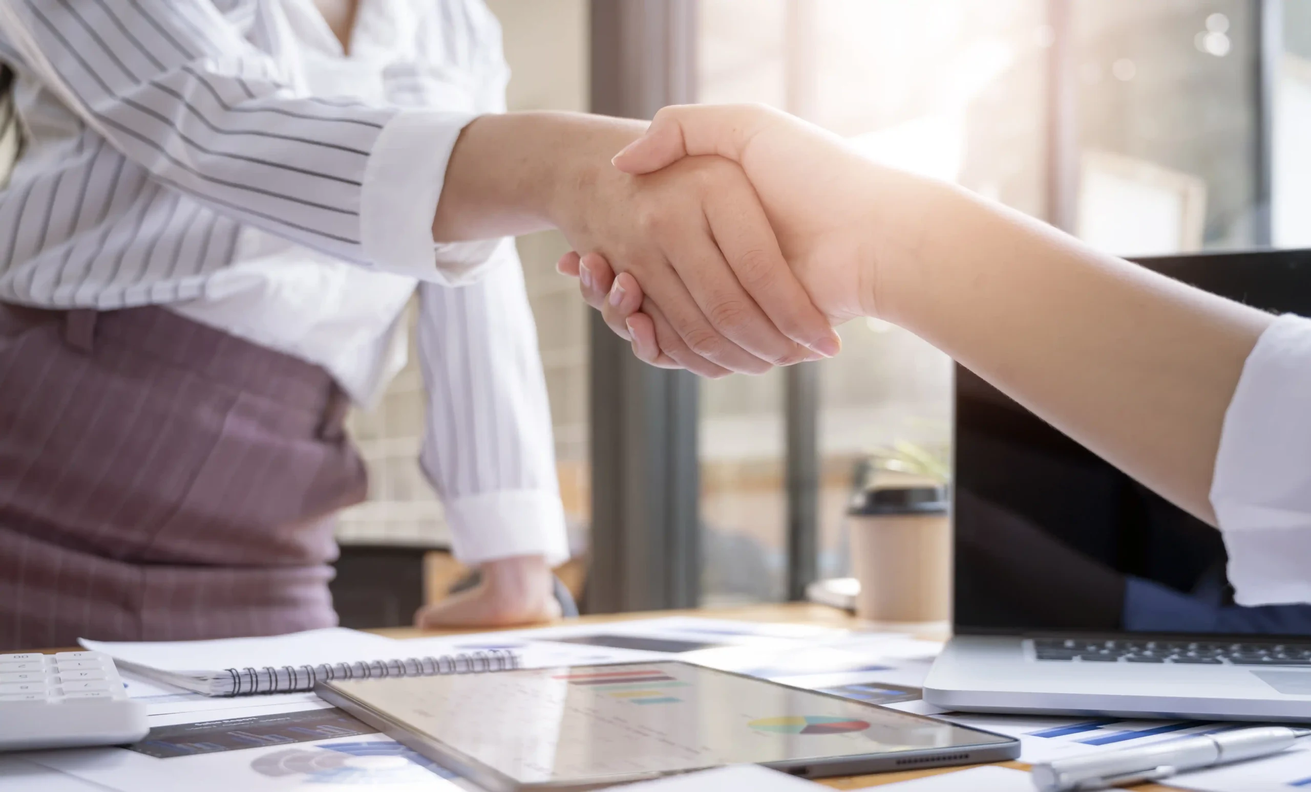 Handshake between two professionals, representing Workvantage's commitment to helping employers secure LMIA approvals and renewals efficiently.