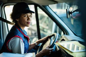 Driver skilled in specialized trades operating a delivery vehicle with focus and precision.