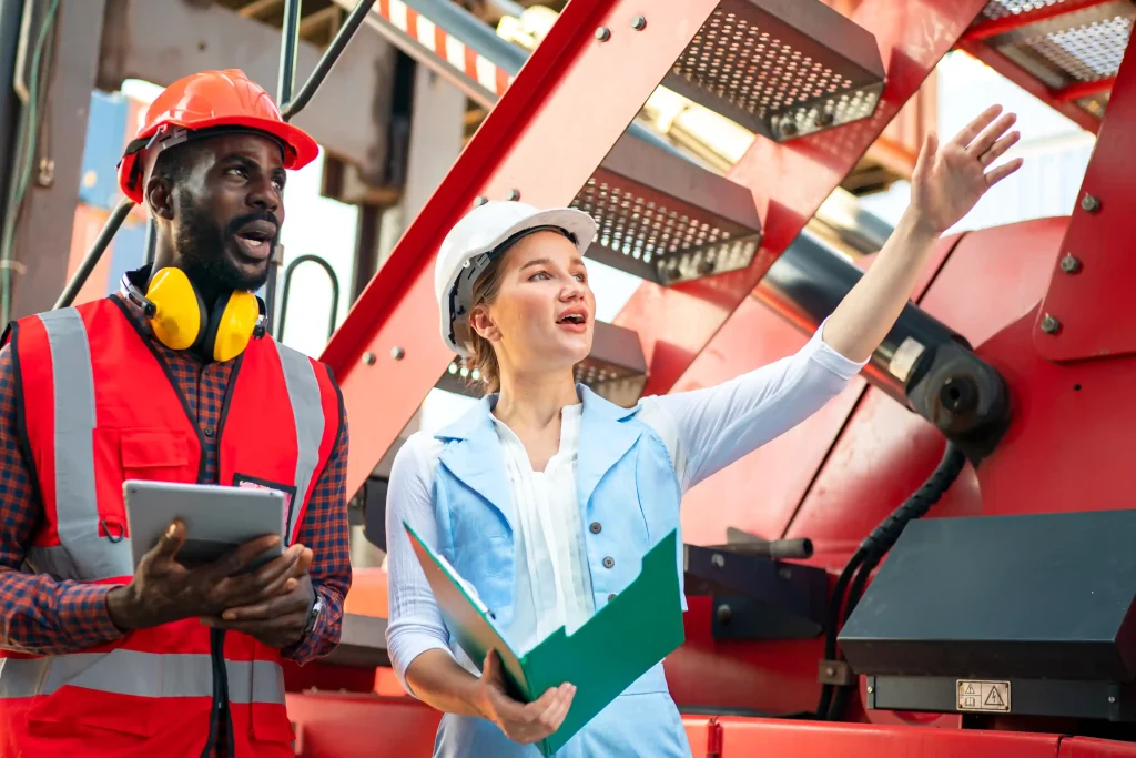 foreman-control-loading-containers-box-from-cargo-freight-ship-import-export-freight-containers Temporary foreign workers discussing seasonal staffing tasks at an industrial site.
