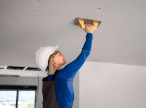 Construction worker installing drywall on a construction project, highlighting the specialized construction staffing solutions provided by Workvantage.