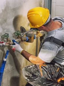 Worker installing water pipes. Workvantage provides experienced workers for plumbing and construction projects, ensuring high-quality installation and repair services for businesses and infrastructure.